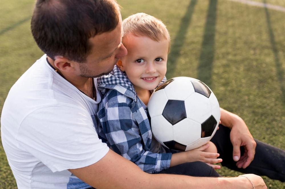 father-son-playing-football-field-high-view