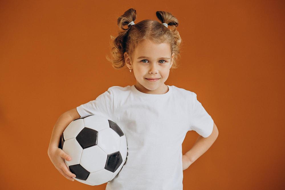 little-girl-player-holding-football-ball